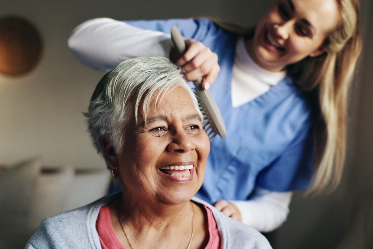 brush-help-and-nurse-with-patient-for-hair-in-ret-2025-04-06-07-13-20-utc Brush, help and nurse with patient for hair in retirement home at healthcare consultation. Happy, m.